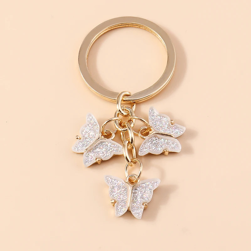 Porte-clés papillon en résine colorée avec paillettes - couleur Blanc