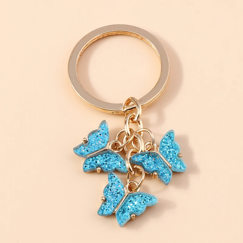 Porte-clés papillon en résine colorée avec paillettes - couleur Bleu